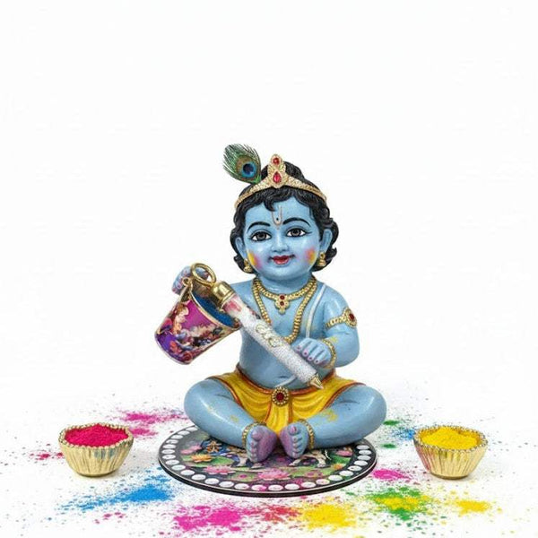 Sitting Krishna figurine on decorated plate with two gold bowls