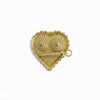 Heart-shaped gold jeweled charm with loop and eye details