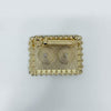 Gold-tone rectangular decorative pichkari accessory with ornate border and circular motifs