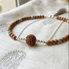 Four-faced rudraksha bead pendant necklace with silver-toned chain