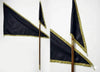 Black flags on poles with golden lace border, pointed fly edges