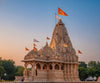 Saffron religious flags flying above a temple spire