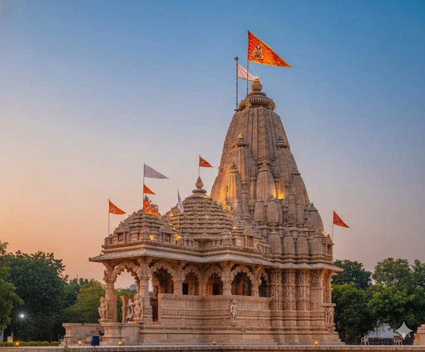 Saffron religious flags flying above a temple spire