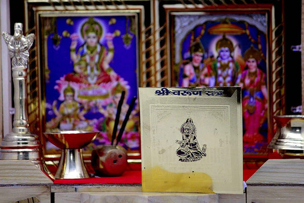 Yantra card on clear acrylic stand with seated deity emblem