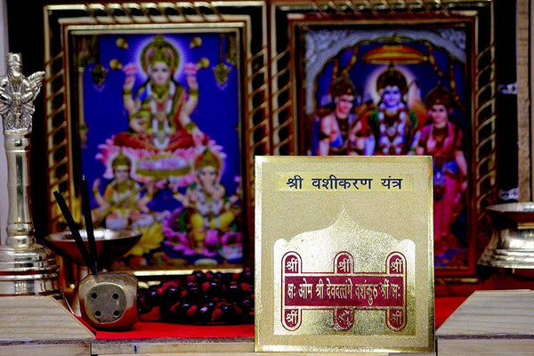 Vashikaran yantra with stand display: framed card with deity art and tan inscription