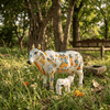Handcrafted cow idol with calf, white body with colorful painted figures and a metal bell