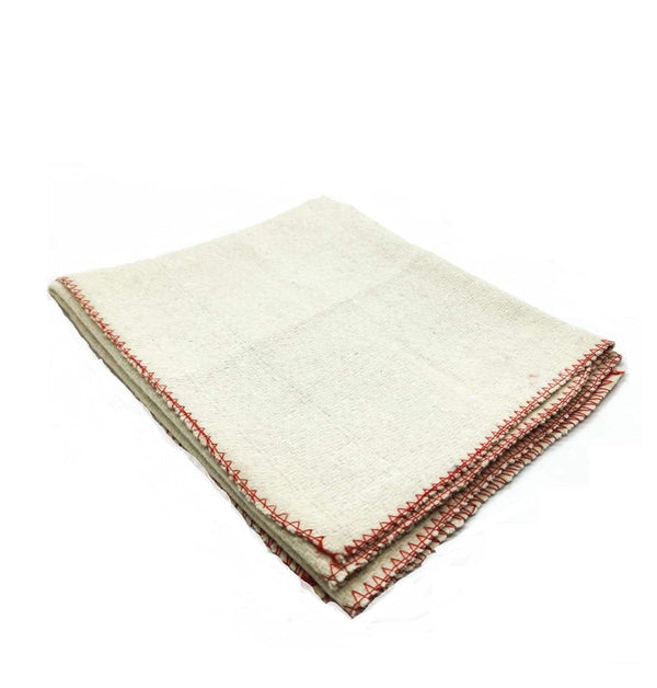 Cream wool meditation mat with red stitched border, neatly folded