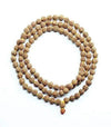 Rudraksha bead mala with light brown speckled beads and small centerpiece charm