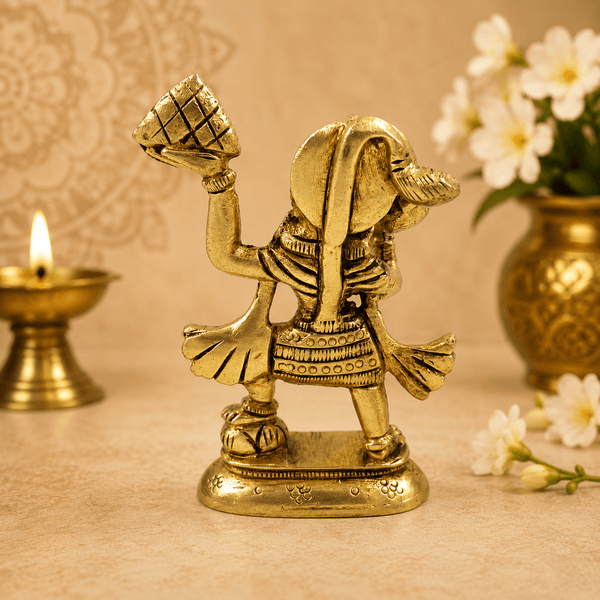 Golden Hanuman idol with raised mace and mountain, side/back view on base