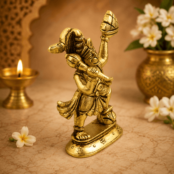 Golden Hanuman idol standing, raised mace and hands holding a mountain