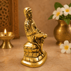 Golden Sai Baba idol statue, seated pose with right hand raised, carved folds
