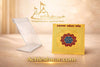 Gold yantra card with circular emblem beside a clear acrylic display stand
