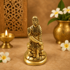 Golden Sai Baba idol statue, front view seated, hands together, carved garments