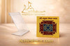 Gold-plated yantra card on a clear acrylic tabletop stand