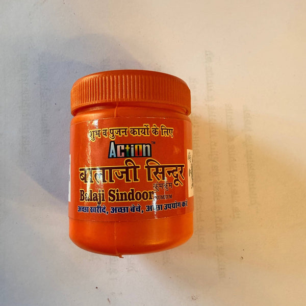Red sindoor powder jar with ribbed orange screw cap
