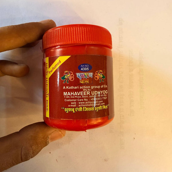Lal sindur powder jar with red lid and side text label held in hand