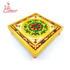 Embroidered square chowki top with gold fabric and green-red floral center, corner trim