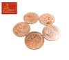 Five copper coins with ornate faces and patterns