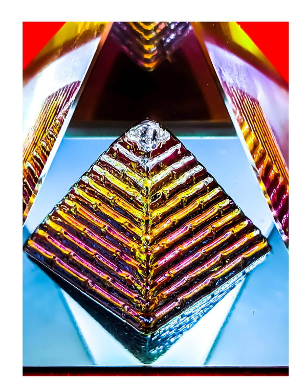 Close-up iridescent crystal pyramid with rainbow striped facets