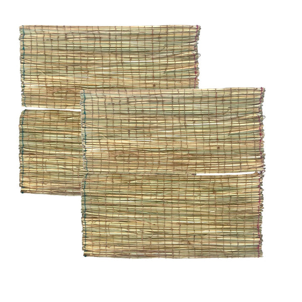Set of darbha grass mats, stacked woven rectangles in green and straw tones