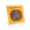 Gold-toned yantra card in clear acrylic stand, close-up angled view