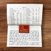Open religious Hindi vrat katha book with printed text pages and small colored seal