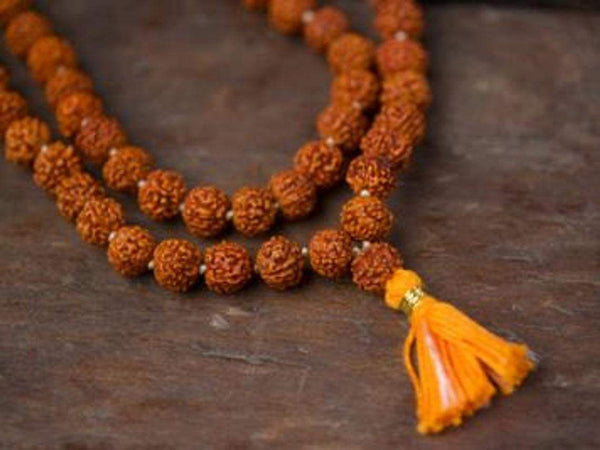 Rudraksh mala necklace with orange-brown beads and yellow tassel
