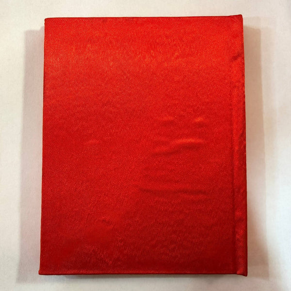 Red pocket book cover with plain fabric texture, no visible text