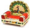 Peacock design wooden singhasan with red cushioned seat, carved sides, and gold-green back