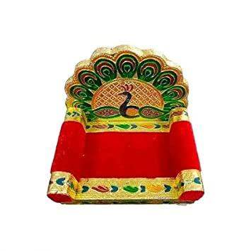 Peacock-themed wooden throne seat with ornate green and gold arch and red cushion