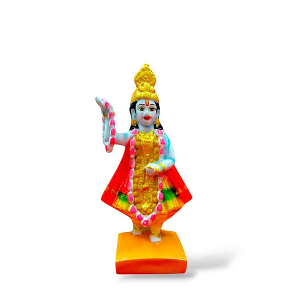 Blue-skinned goddess statue with gold crown, red-and-green skirt, raised hand, yellow base
