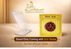 Clear acrylic stand holding a small yellow square yantra card with maroon design