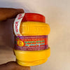 Chandan powder jar with red cap and yellow label, for puja rituals