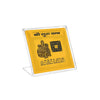 Gold yantra plaque placed in a clear acrylic stand