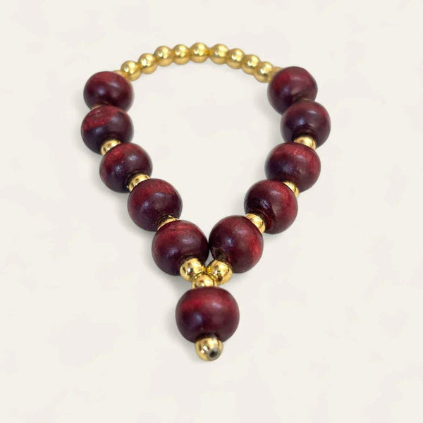 Maroon sandalwood mala bracelet with gold beads and small hanging bell