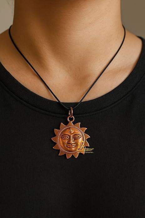 Copper sun-face pendant with traditional metal detailing on black cord necklace