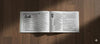 Paperback panchang book, open to two pages with dense printed text columns